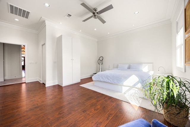 bedroom featuring dark wood-style floors, ornamental molding, visible vents, and recessed lighting