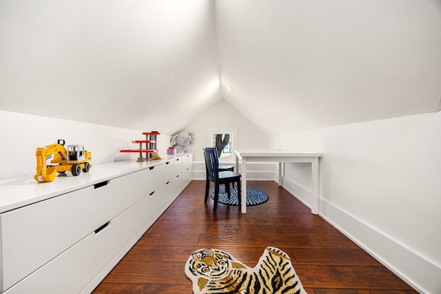 office space featuring baseboards, vaulted ceiling, and dark wood-style flooring