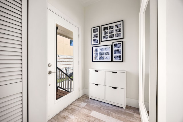 entryway with light wood-type flooring and baseboards