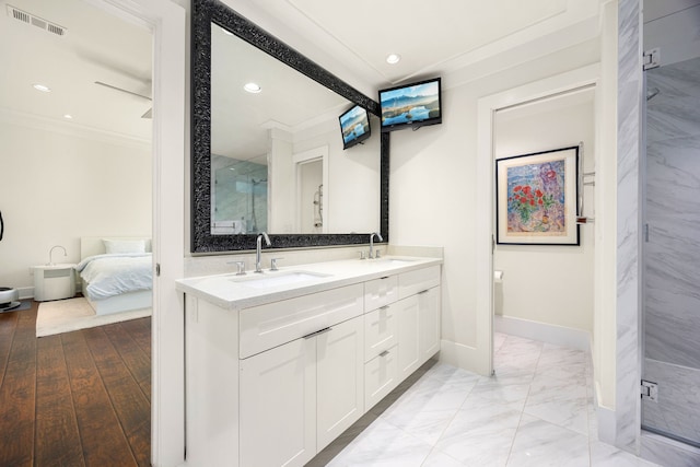 full bath featuring double vanity, a sink, visible vents, and recessed lighting