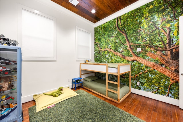 unfurnished bedroom featuring wood ceiling, visible vents, baseboards, and wood finished floors