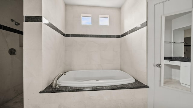 bathroom featuring separate shower and tub and tile walls