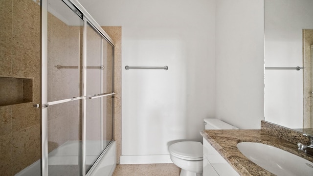 full bathroom featuring enclosed tub / shower combo, vanity, and toilet