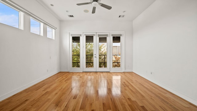 spare room with light wood-type flooring and ceiling fan