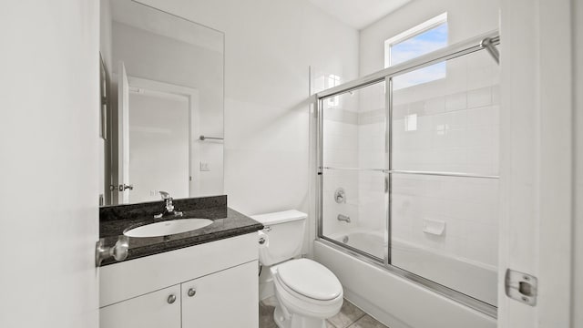 full bathroom featuring toilet, vanity, and enclosed tub / shower combo