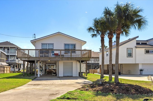 coastal inspired home featuring a carport, a front yard, and concrete driveway