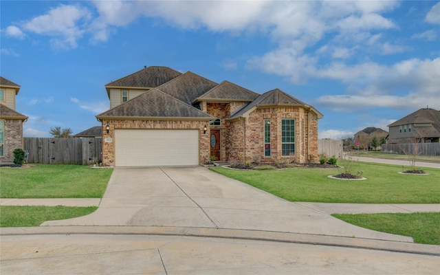 view of front facade with an attached garage, driveway, brick siding, and a front yard