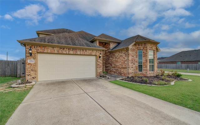 view of front of property with a garage, brick siding, fence, driveway, and a front yard