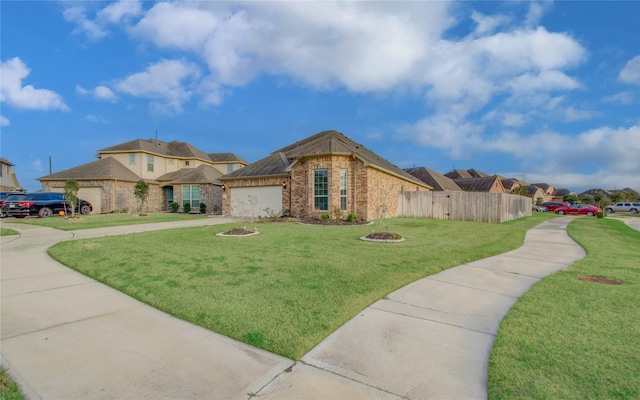 view of front of house with concrete driveway, an attached garage, fence, a front lawn, and brick siding