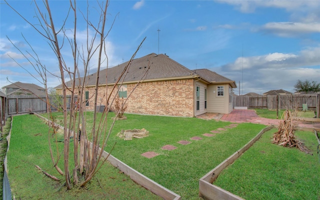 view of yard with a patio area and a fenced backyard