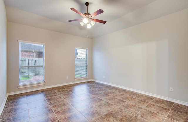 unfurnished room featuring a ceiling fan and baseboards