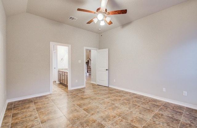 unfurnished room featuring lofted ceiling, baseboards, visible vents, and a ceiling fan