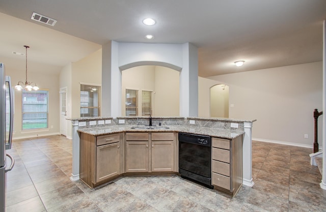 kitchen featuring light stone counters, a sink, visible vents, black dishwasher, and pendant lighting