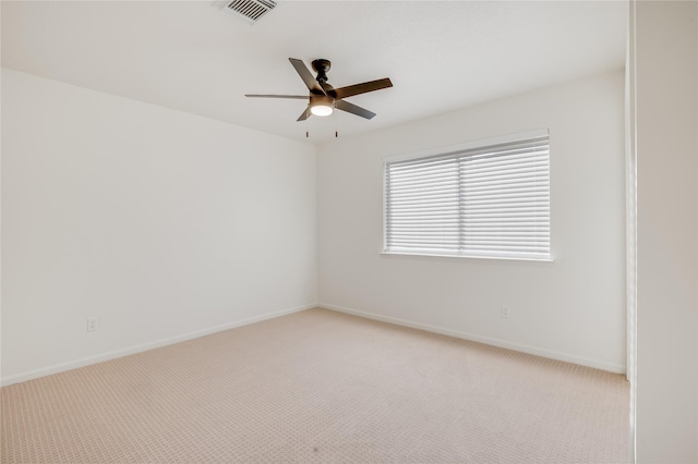 unfurnished room with light colored carpet and ceiling fan