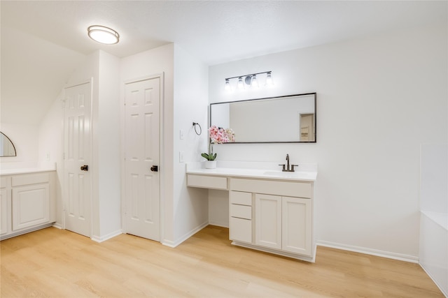 bathroom with hardwood / wood-style flooring and vanity