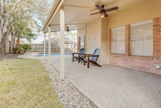 view of patio / terrace featuring a fenced in pool and ceiling fan