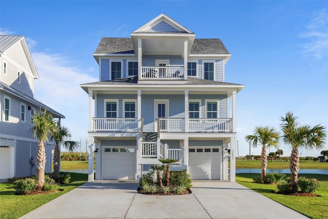 coastal inspired home featuring a garage, a balcony, and a porch