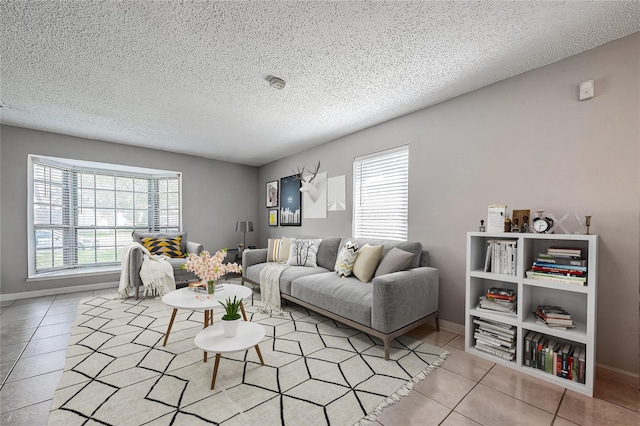 8619 Quail Burg Ln, Houston, TX 77489 - living room with tile patterned floors, healthy amount of natural light, baseboards, and a textured ceiling
