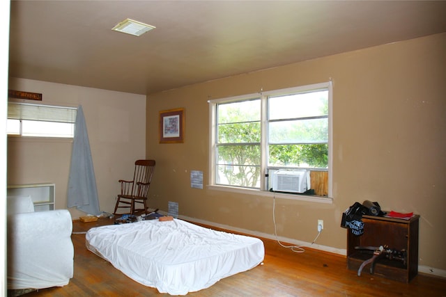 bedroom featuring cooling unit and wood-type flooring