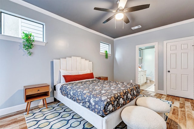 bedroom featuring ensuite bathroom, light hardwood / wood-style floors, ceiling fan, and ornamental molding