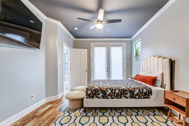 bedroom featuring ornamental molding, light wood-type flooring, multiple windows, and french doors