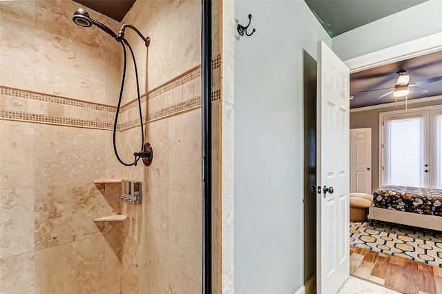 bathroom featuring french doors, a shower with shower door, and ceiling fan