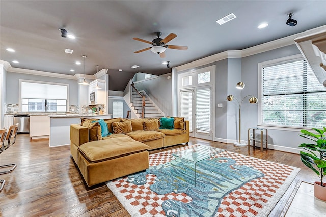 living room with ceiling fan, dark hardwood / wood-style flooring, and ornamental molding