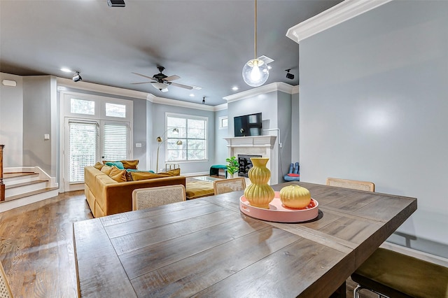 dining room featuring ornamental molding, hardwood / wood-style floors, and ceiling fan