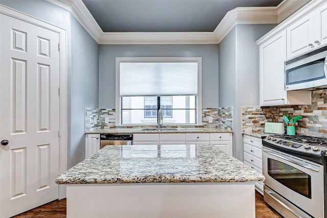 kitchen with sink, white cabinetry, stainless steel appliances, and light stone counters