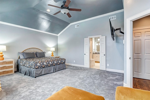 carpeted bedroom with vaulted ceiling, crown molding, ceiling fan, and ensuite bath