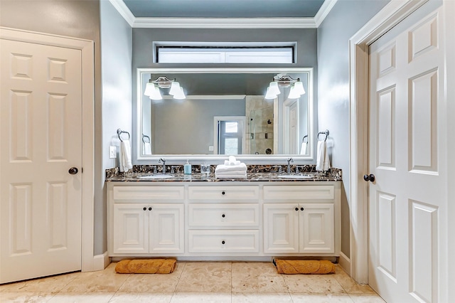 bathroom with crown molding, vanity, and a shower with door