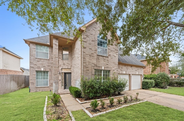 traditional-style home featuring brick siding, concrete driveway, fence, a garage, and a front lawn