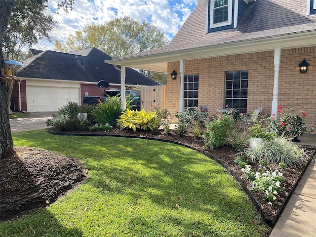 view of front of property featuring a garage, brick siding, roof with shingles, and a front yard