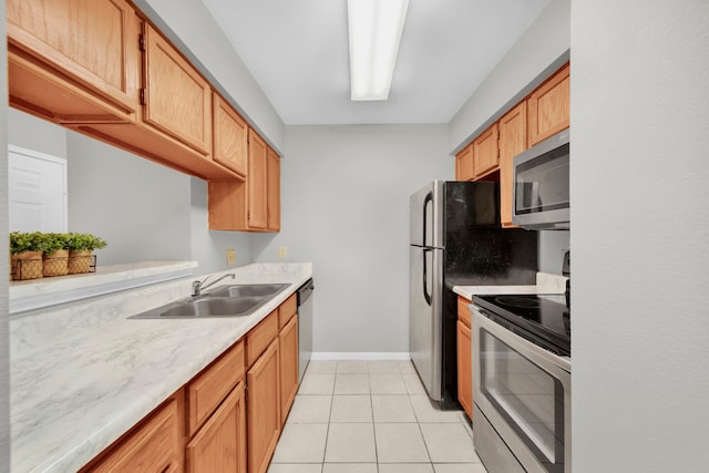 kitchen featuring sink, light tile patterned flooring, and stainless steel appliances