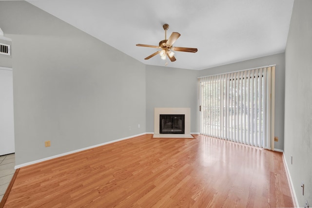 unfurnished living room featuring ceiling fan and light hardwood / wood-style flooring