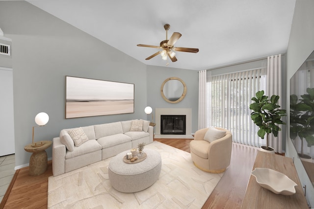 living room with lofted ceiling, ceiling fan, and wood-type flooring