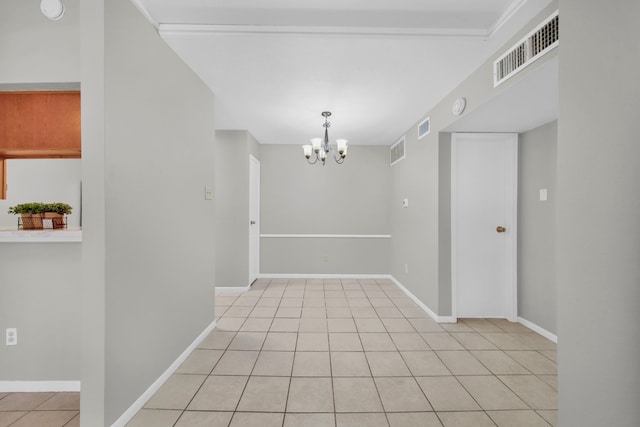 unfurnished room with light tile patterned flooring and a notable chandelier