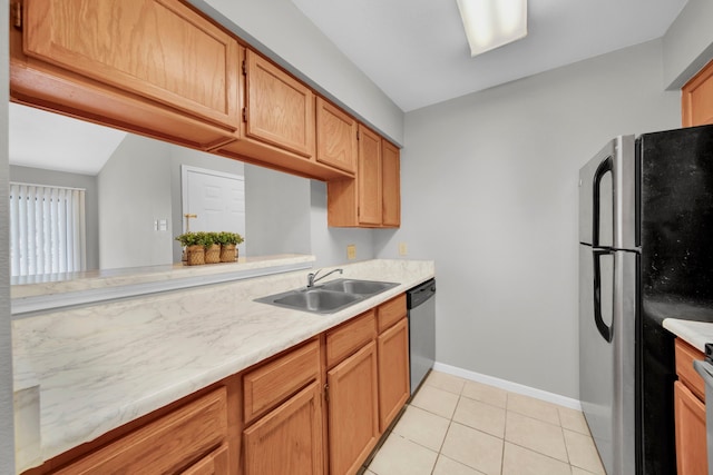 kitchen with light tile patterned flooring, stainless steel appliances, and sink