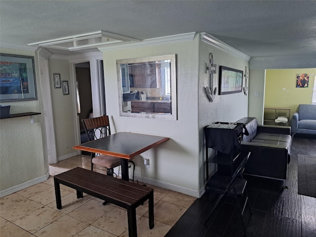 dining room with a textured ceiling and crown molding