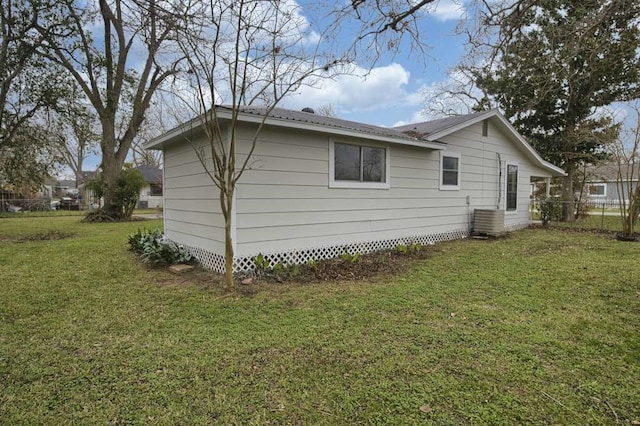 view of side of property with a lawn