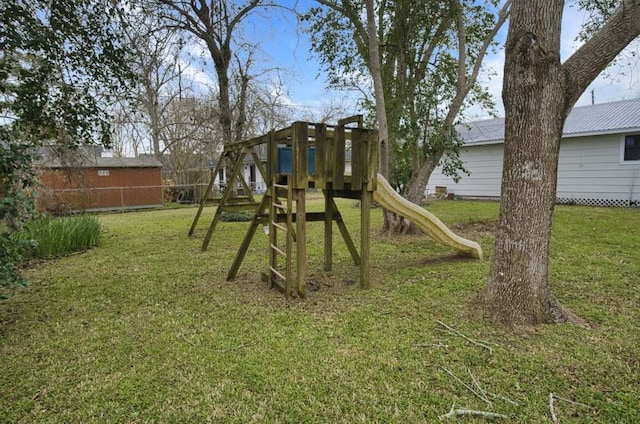 view of playground with a lawn