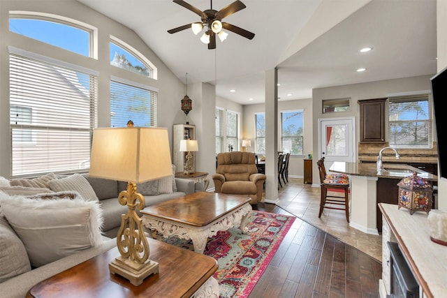 living room with ceiling fan, sink, dark hardwood / wood-style floors, and lofted ceiling