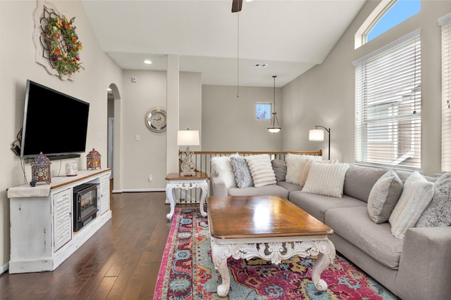 living room featuring dark hardwood / wood-style floors, a wealth of natural light, and lofted ceiling