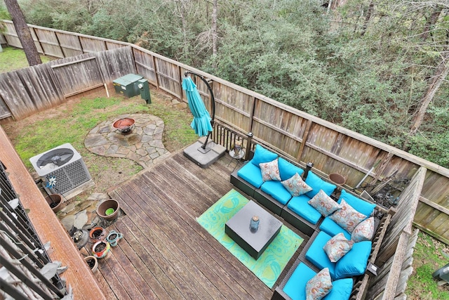 wooden deck featuring cooling unit and an outdoor living space with a fire pit