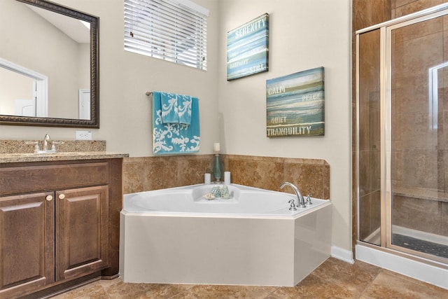 bathroom featuring vanity and independent shower and bath