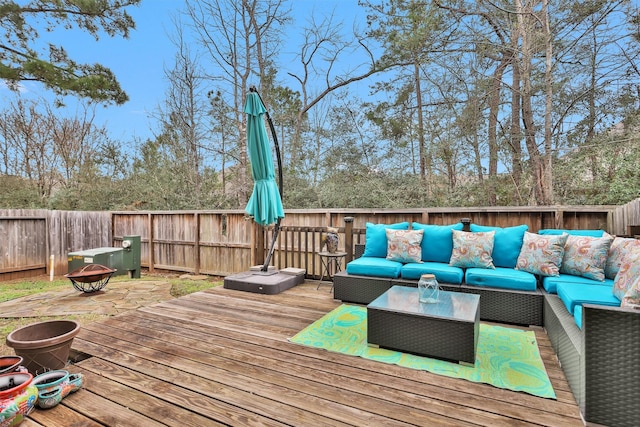 wooden terrace featuring an outdoor living space with a fire pit