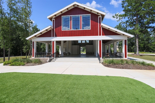 150 Cheswood Forest Dr, Montgomery, TX 77316 - view of front of house with a front yard, driveway, a porch, a carport, and board and batten siding