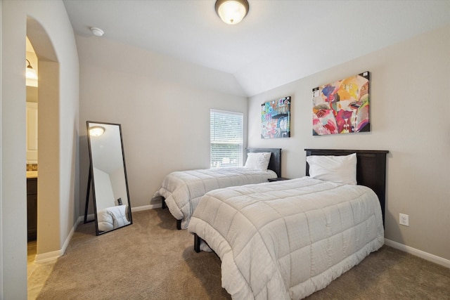 bedroom featuring vaulted ceiling, carpet floors, and baseboards