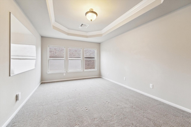 unfurnished room with baseboards, visible vents, a tray ceiling, and carpet flooring