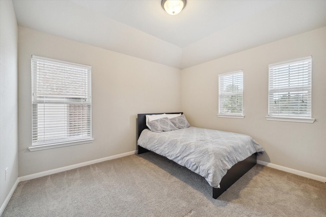 bedroom with carpet floors and baseboards